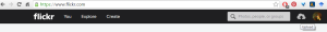 Screenshot shows the top menu on the Flickr Homepage. On the far right of the menu is a cloud image with an arrow inside pointing up. Hover text identifies this as the Upload button. A blue arrow is pointing to the Upload button.