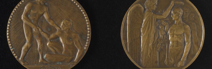 Three metal medals on plain black background
