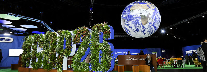 COP26 sign in front of seating areas for attendees