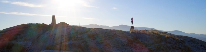 Woman standing on a stone at the top of Blackford Hill