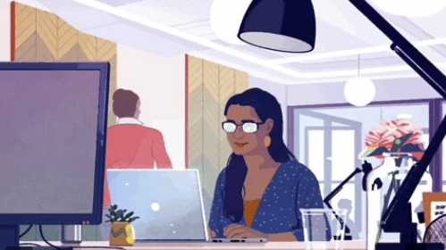 Black woman sitting in beautiful office space in front of a laptop