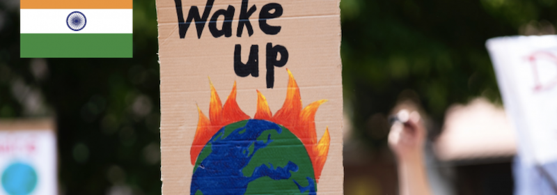 Protest sign of earth on fire and the words wake up