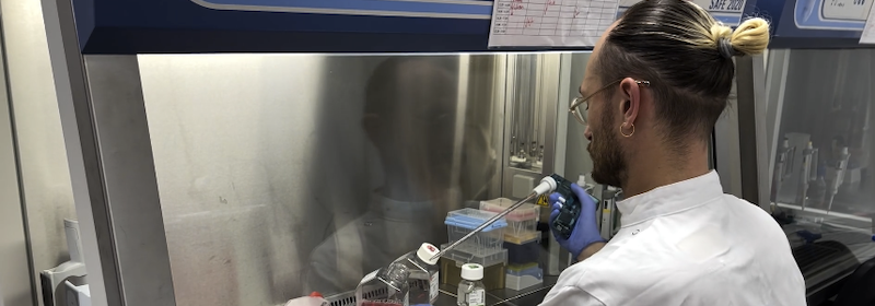 Dr Adam Mol using a pipett