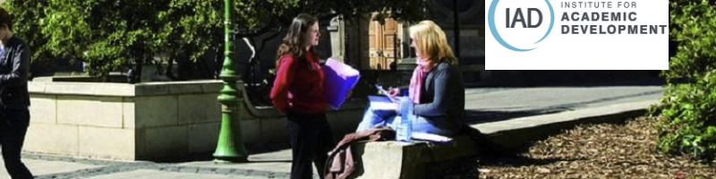 staff and students sitting outside a University