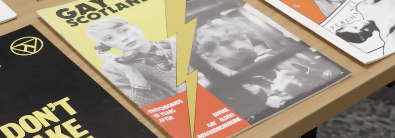 A table with Gay Scotland magazine featuring Switchboard articles
