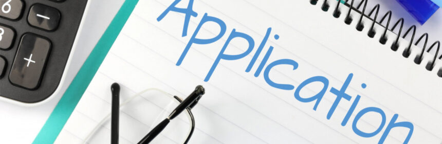 Application written in blue on a white notepad.