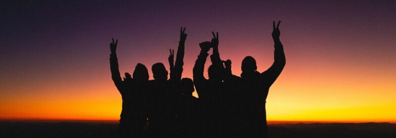 Silhouettes of unrecognisable people in a sunset